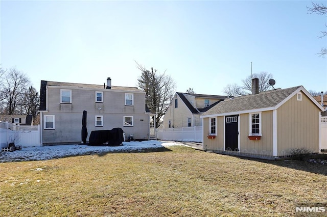 rear view of house with an outbuilding and a lawn