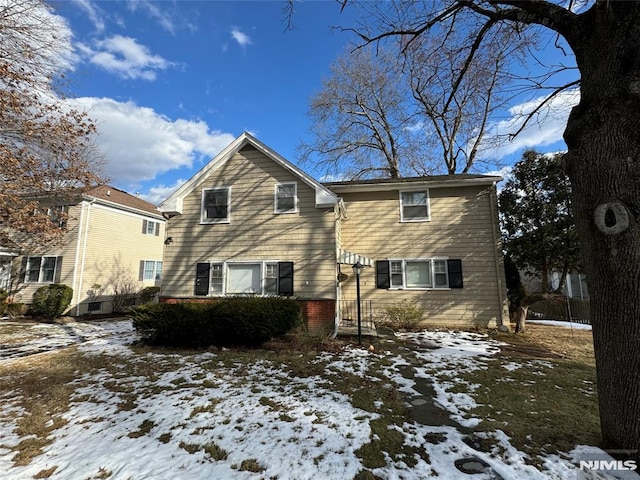 view of snow covered rear of property