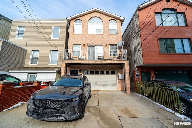 view of property featuring a garage and a balcony