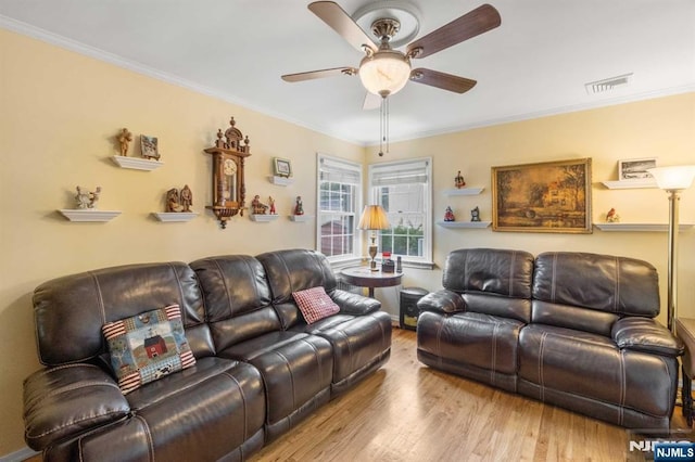 living room featuring ornamental molding, ceiling fan, and light hardwood / wood-style floors