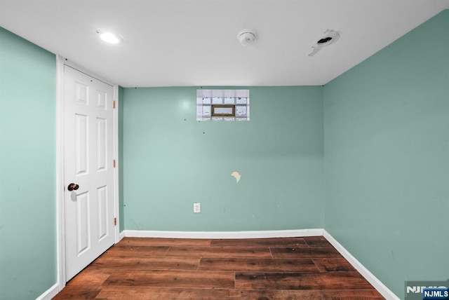 empty room with dark hardwood / wood-style flooring