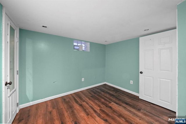 unfurnished room featuring dark wood-type flooring