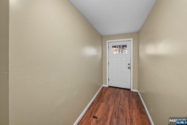 doorway with dark wood-type flooring