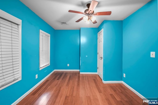 empty room featuring ceiling fan and wood-type flooring