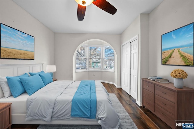 bedroom with dark hardwood / wood-style floors and ceiling fan