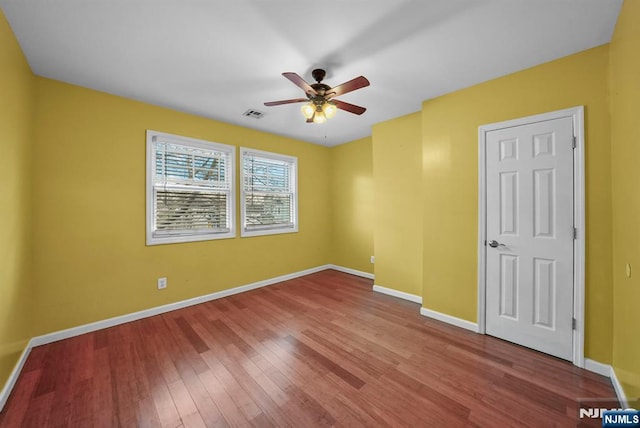 spare room featuring hardwood / wood-style flooring and ceiling fan