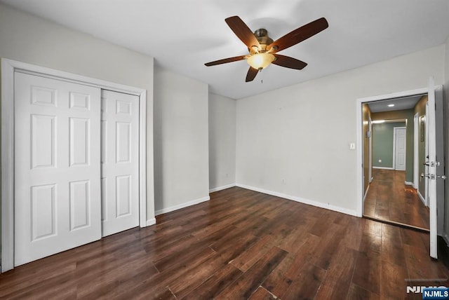 unfurnished bedroom featuring dark hardwood / wood-style flooring, a closet, and ceiling fan