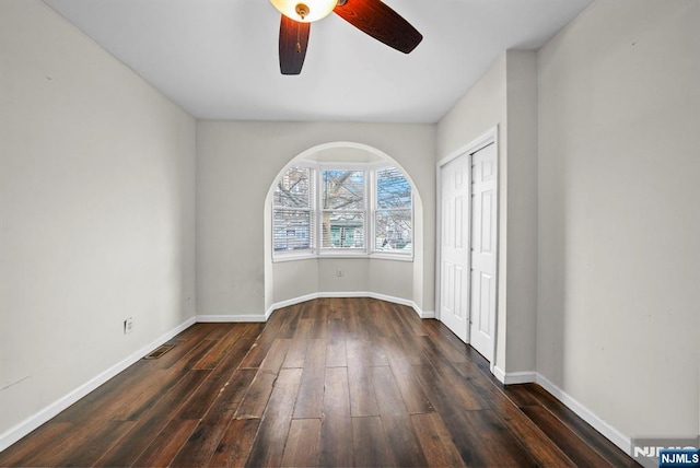 spare room with ceiling fan and dark hardwood / wood-style floors