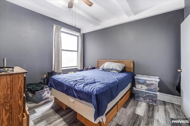 bedroom featuring ceiling fan, dark wood-type flooring, beamed ceiling, and baseboards