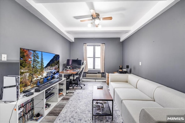 office featuring a ceiling fan, beam ceiling, and wood finished floors