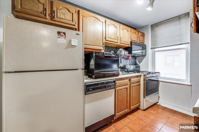 kitchen with white appliances, light countertops, and light tile patterned flooring