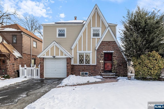 tudor house featuring a garage