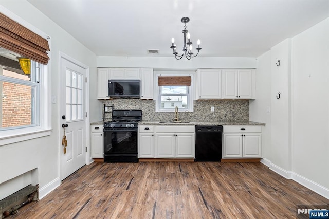 kitchen with white cabinets, sink, and black appliances