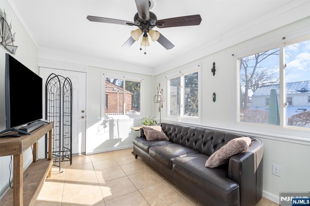 tiled living room with crown molding and ceiling fan