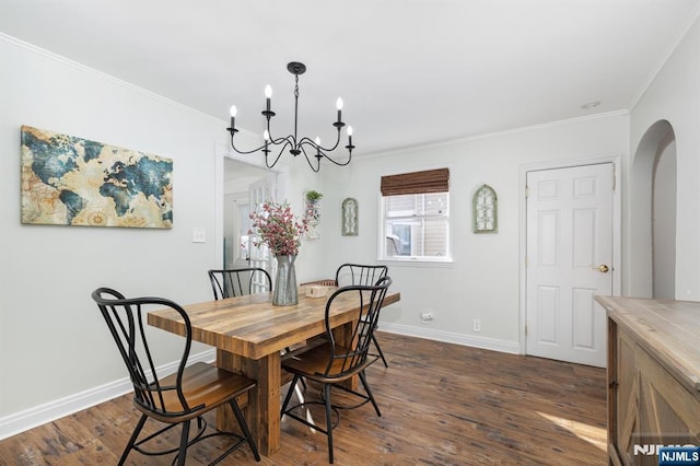 dining room with ornamental molding, dark hardwood / wood-style floors, and a chandelier