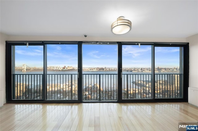 unfurnished sunroom featuring a water view and plenty of natural light