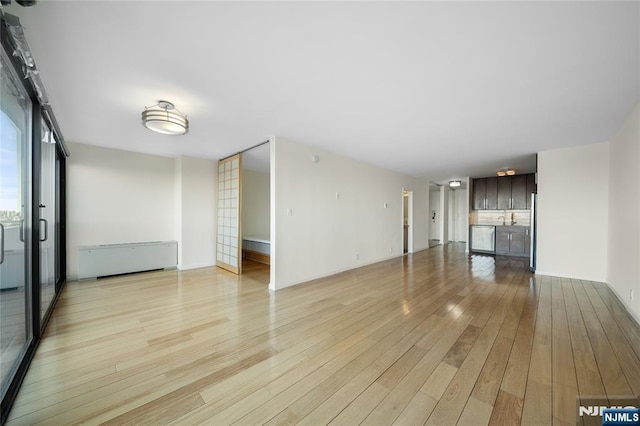 unfurnished living room with light wood-type flooring