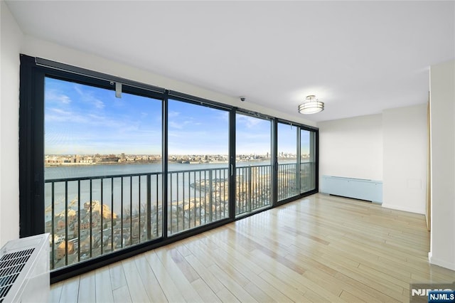 unfurnished sunroom with a water view