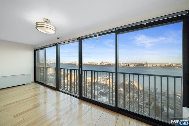 unfurnished sunroom featuring a water view