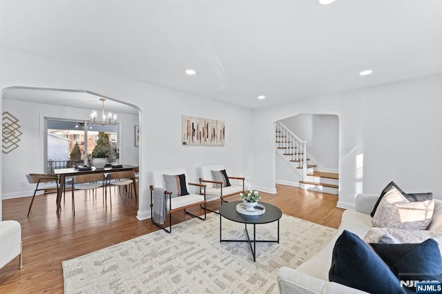 living room featuring light hardwood / wood-style flooring and a notable chandelier