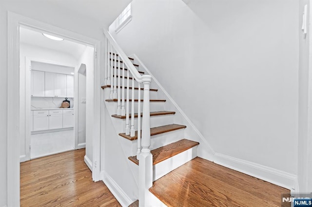 staircase featuring hardwood / wood-style flooring