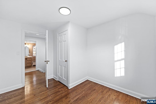 hall with radiator and dark hardwood / wood-style flooring