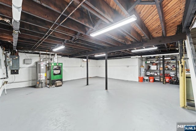 basement featuring water heater and electric panel