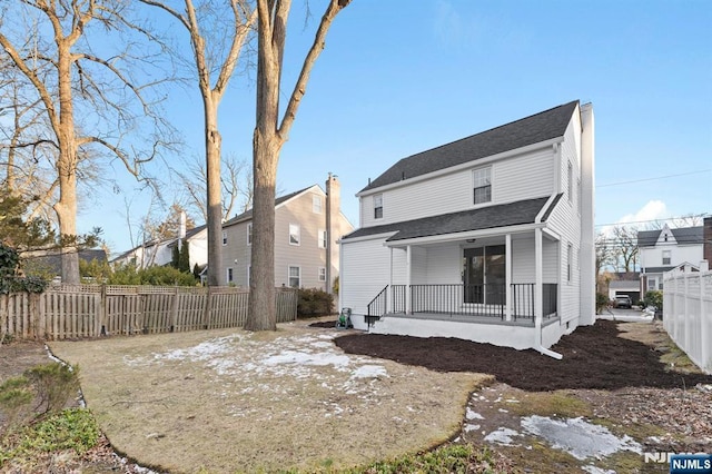 back of property with covered porch