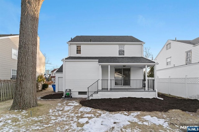 snow covered property with a porch