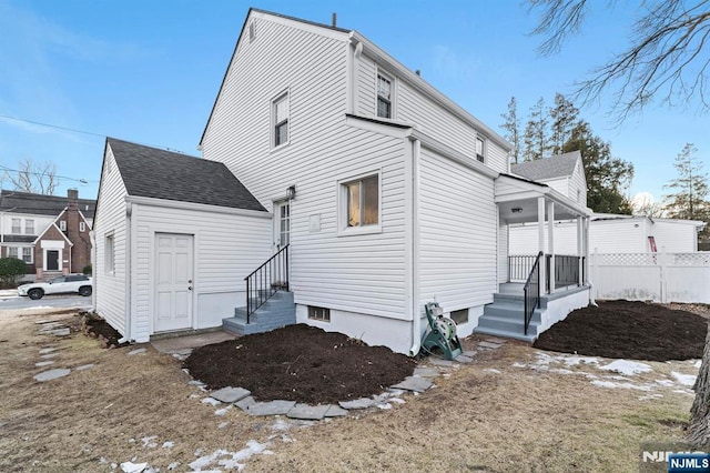 rear view of house with a porch