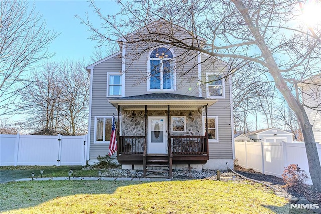 view of front facade with a front yard and a porch