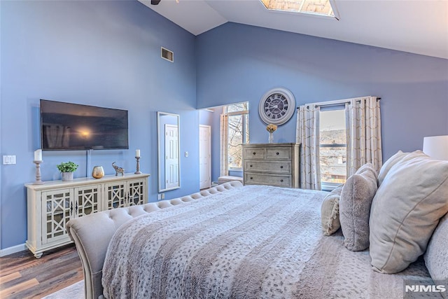 bedroom featuring hardwood / wood-style floors and high vaulted ceiling