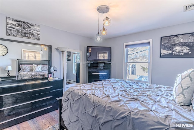 bedroom with hardwood / wood-style flooring