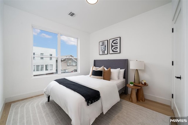 bedroom with light hardwood / wood-style flooring