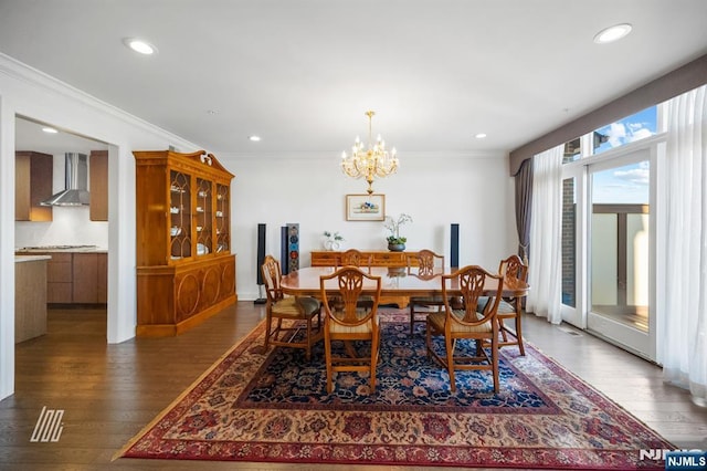 dining space featuring ornamental molding, dark hardwood / wood-style floors, and a chandelier