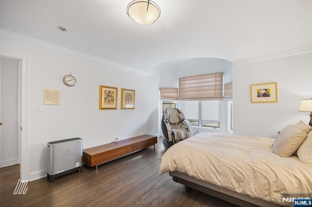 bedroom with crown molding and dark hardwood / wood-style flooring