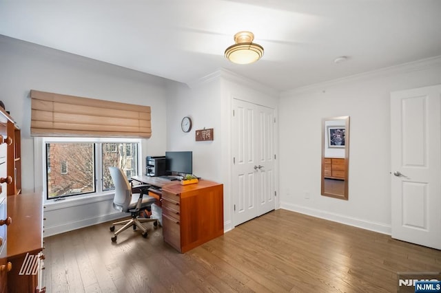 home office featuring ornamental molding and hardwood / wood-style floors