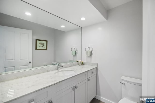 bathroom featuring vanity and toilet