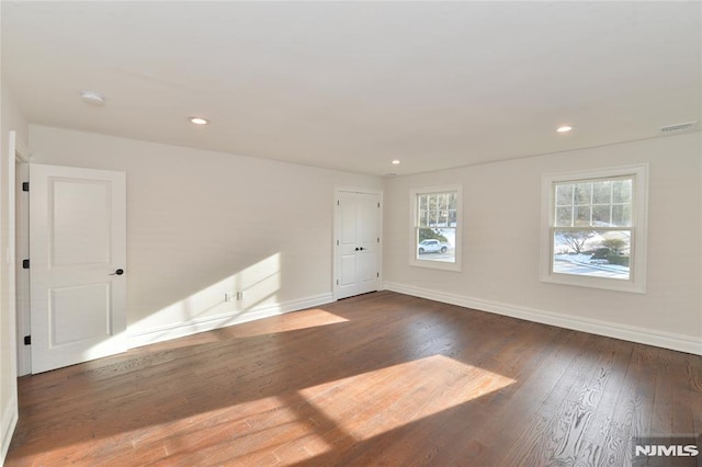 spare room with dark wood-type flooring