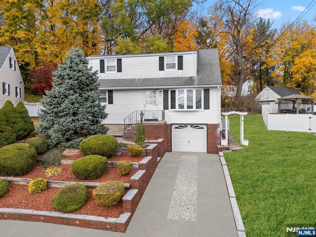 view of front of property with a garage and a front yard