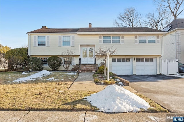 bi-level home with french doors and a garage