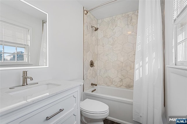 full bathroom with shower / bath combination with curtain, a healthy amount of sunlight, toilet, and vanity