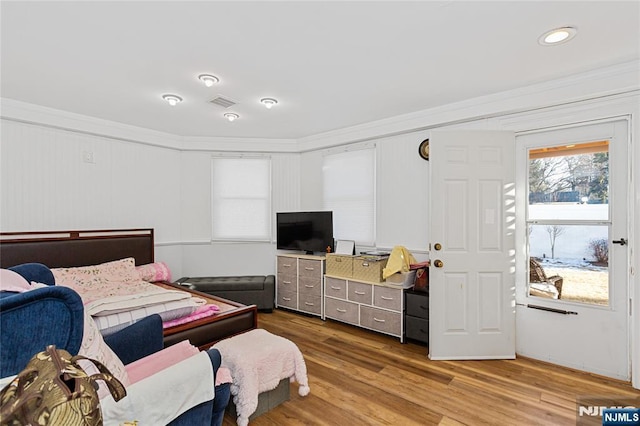 bedroom featuring ornamental molding and hardwood / wood-style floors