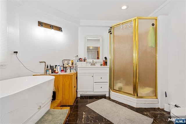 bathroom with ornamental molding, vanity, independent shower and bath, and tile walls