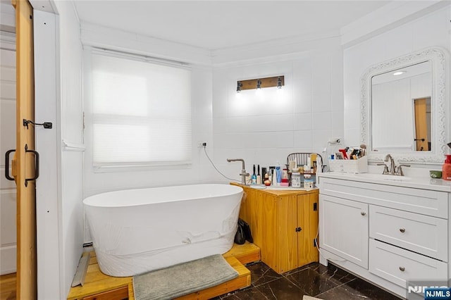 bathroom featuring vanity, tile walls, and a bathing tub