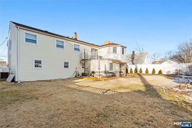 rear view of property with a patio and a lawn