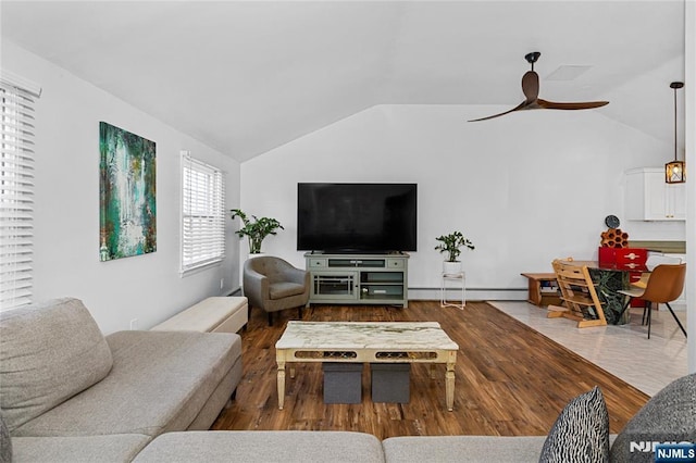 living room featuring lofted ceiling, hardwood / wood-style floors, a baseboard radiator, and ceiling fan