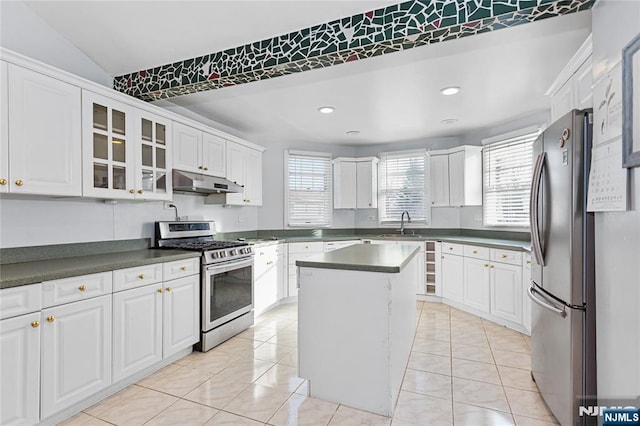 kitchen featuring a kitchen island, white cabinetry, and appliances with stainless steel finishes