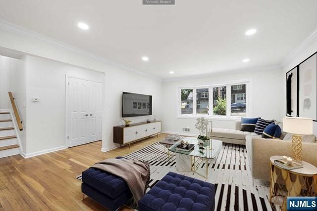 living room featuring hardwood / wood-style flooring and crown molding