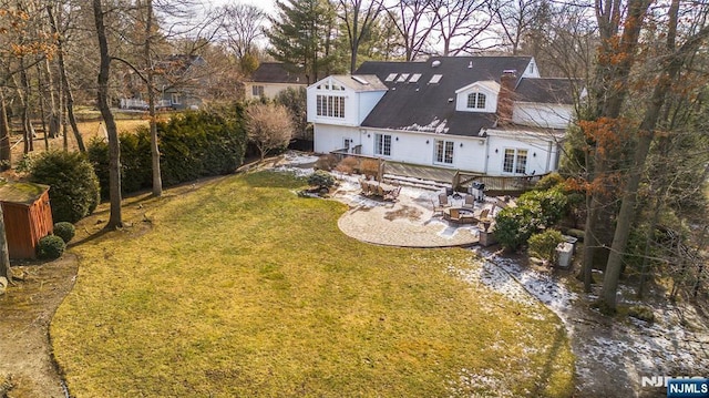 back of property with a patio area, fence, and a yard